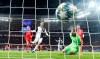 Juventus' Cristiano Ronaldo, center, scores the opening goal against Leverkusen's goalkeeper Lukas Hradecky during the Champions League Group D soccer match between Bayer Leverkusen and Juventus at the BayArena in Leverkusen, Germany, Wednesday, Dec. 11, 2019. (AP Photo/Martin Meissner)