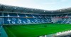Only a few workers stand on the pitch of the empty stadium of German Bundesliga soccer club Borussia Moenchengladbach in Moenchengladbach, Germany, Thursday, April 16, 2020. All major events in Germany are suspended due to the coronavirus outbreak until the end of August, the German Bundesliga suspended all matches until April 30, 2020. (AP Photo/Martin Meissner)