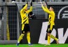Dortmund's Jadon Sancho, left, celebrates with Dortmund's Raphael Guerreiro after scoring his side's second goal during the German Bundesliga soccer match between Borussia Dortmund and VfL Wolfsburg in Dortmund, Germany, Sunday, Jan. 3, 2021. (AP Photo/Martin Meissner, Pool)