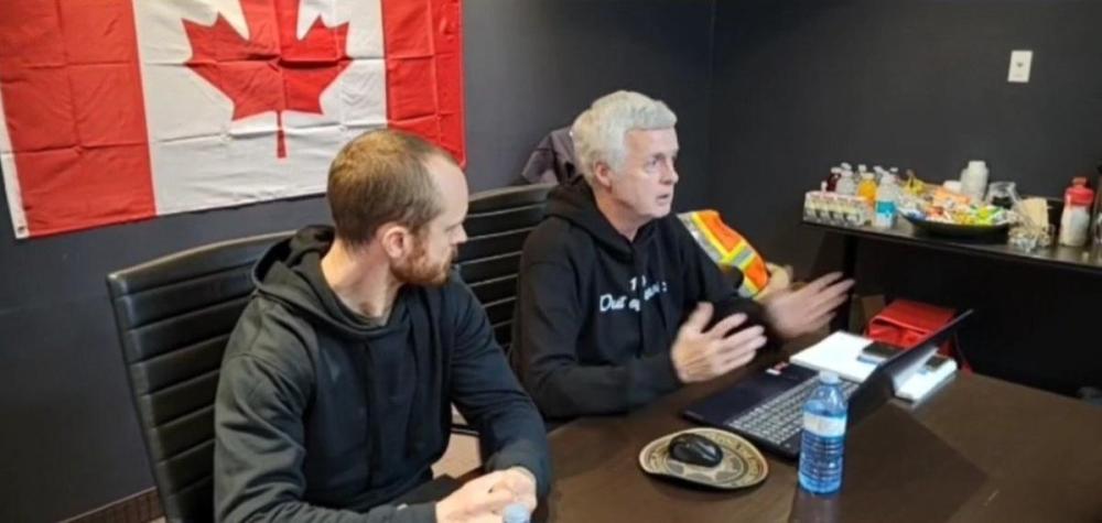 Tom Quiggin, right, and Daniel Bulford talk to supporters of the Ottawa occupation during a press conference.