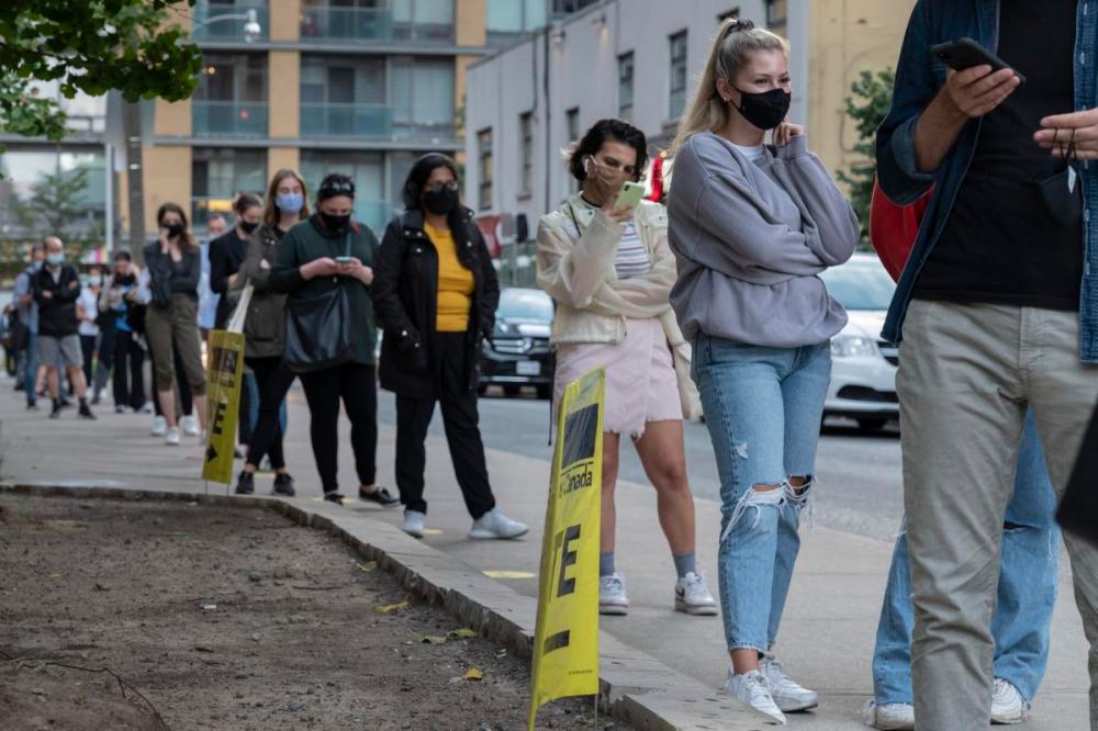 Ian Willms - GETTY IMAGES
Voters line up at the Toronto Public Library - Parkdale Branch on September 20, 2021 in Toronto, Canada. Canadians are going to the polls amid the COVID-19 pandemic after Prime Minister Justin Trudeau of the Liberal party called an election. This election saw a record turnout to advance polls prior to election day.