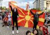 ROBERT ATANASOVSKI - AFP via GETTY IMAGES
Supporters react with a flag of North Macedonia as they watch the UEFA EURO 2020 Group C football match between Austria and North Macedonia in downtown Skopje on June 13, 2021.