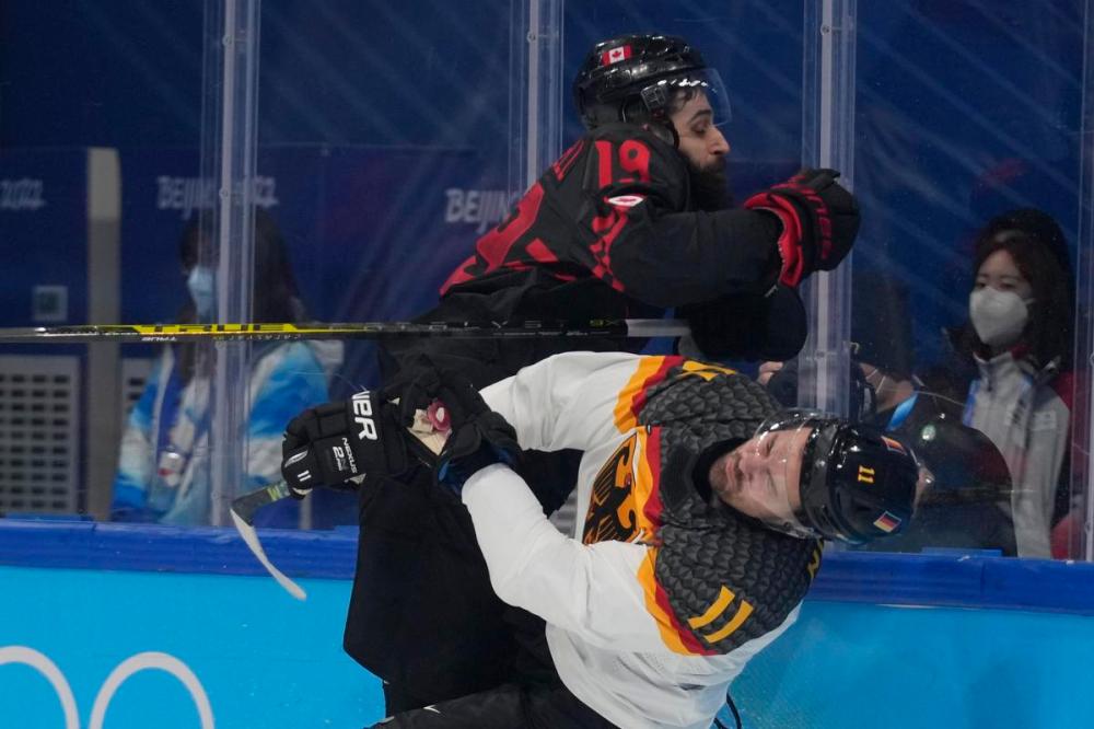Petr David Josek - AP
Canada's Eric O'Dell, top, checks Germany's Marco Nowak in the opening few minutes of their preliminary round men's hockey game at the 2022 Winter Olympics on Thursday in Beijing.