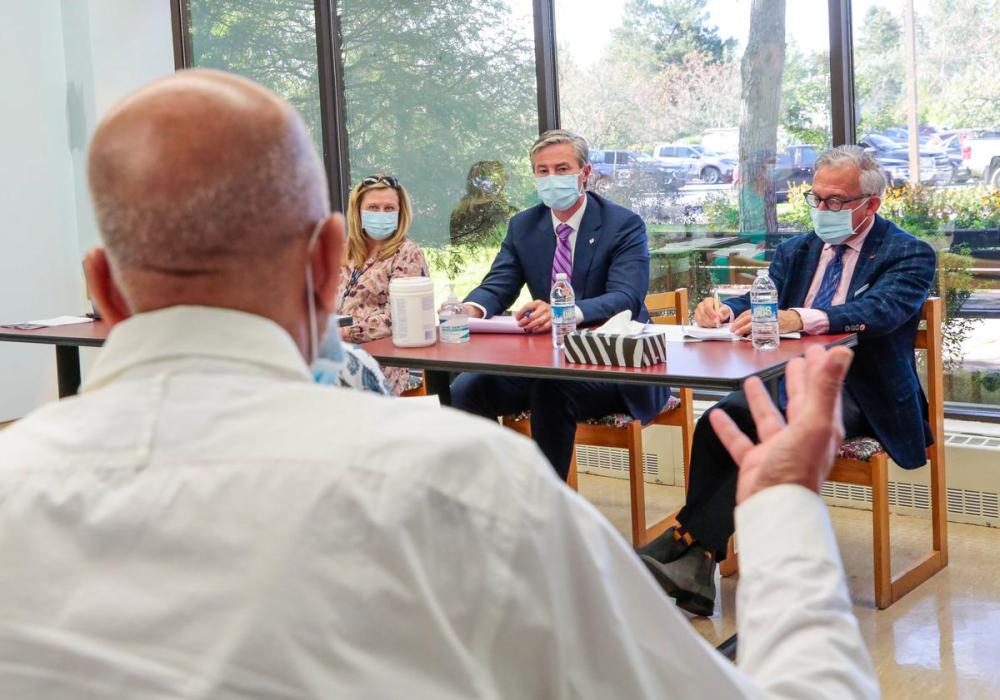 - Province of Nova Scotia
Nova Scotia Premier Tim Houston (centre) and Dr. Kevin Orell (right), CEO of the province’s Office of Healthcare Professionals Recruitment, speak with health-care stakeholders in Windsor, N.S. in this September file photo.