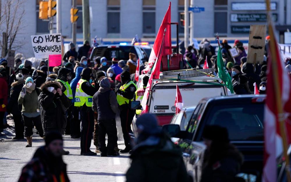 Justin Tang - THE CANADIAN PRESS
Police work on Feb. 13, 2022, as local residents participate in a counter protest, preventing vehicles from driving in a convoy en route to Parliament Hill, on the 17th day of a protest against COVID-19 measures that has grown into a broader anti-government protest.