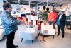 A sales clerk keeps his distance from clients at a furniture store in St-Jean-sur-Richelieu, Que. on Monday, May 4, 2020. Retail stores outside the greater Montreal area have been allowed to reopen after weeks of forced closure due to the COVID-19 pandemic. THE CANADIAN PRESS/Paul Chiasson