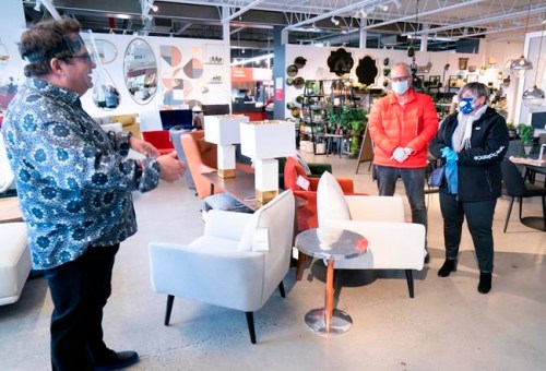 A sales clerk keeps his distance from clients at a furniture store in St-Jean-sur-Richelieu, Que. on Monday, May 4, 2020. Retail stores outside the greater Montreal area have been allowed to reopen after weeks of forced closure due to the COVID-19 pandemic. THE CANADIAN PRESS/Paul Chiasson