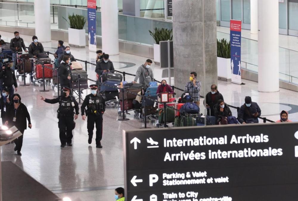 - Toronto Star
International passengers off a flight to Toronto wait in line at the airport to board busses to quarantine hotels. Seven workers at the Holiday Inn Toronto Airport have tested positive for COVID-19.