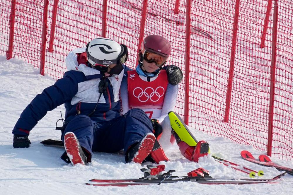 Robert F. Bukaty - The Associated Press
A team member consoles American alpine skiing star Mikaela Shiffrin, who went off course early at the Olympics in her specialty, the slalom.