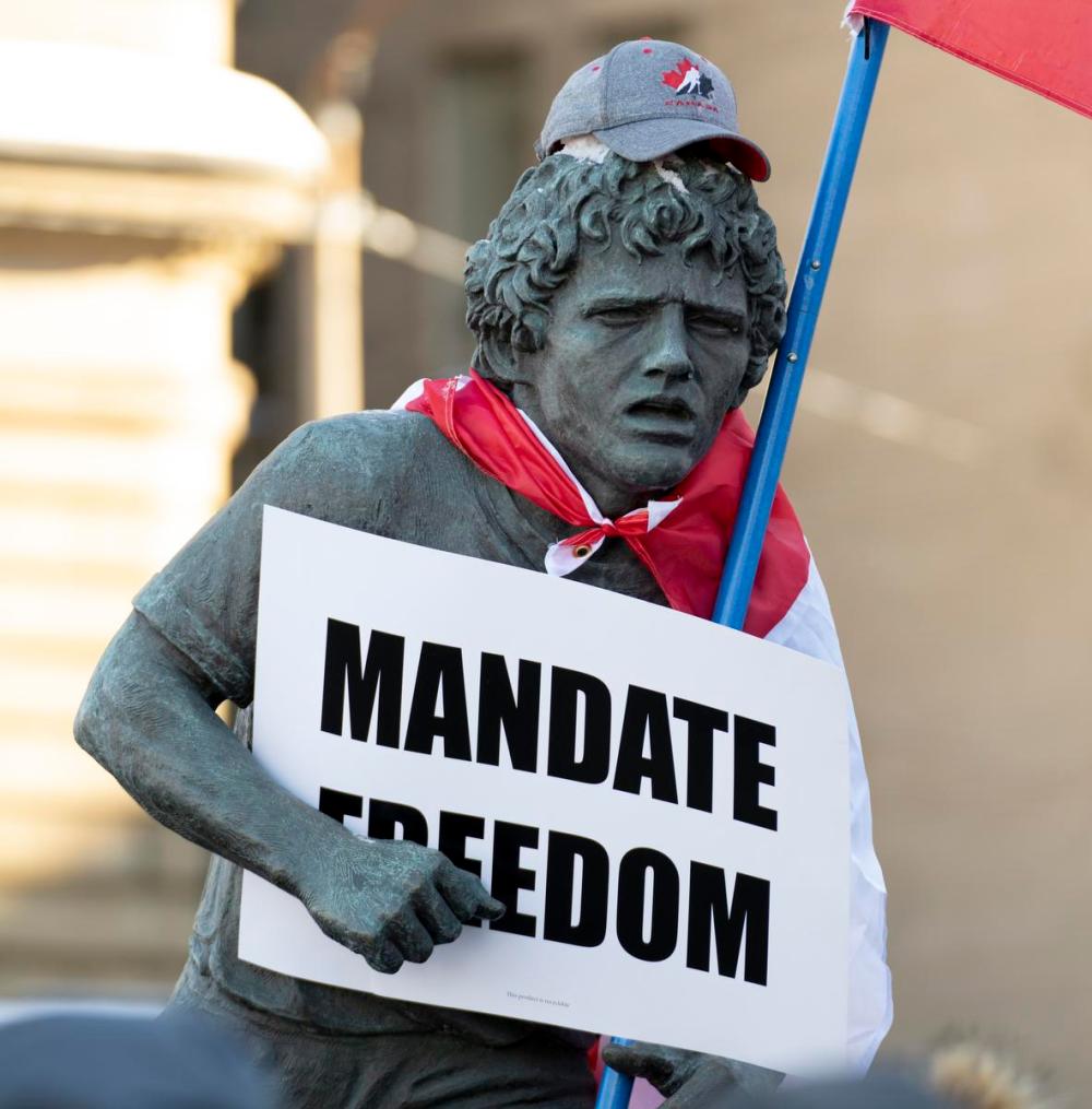 Adrian Wyld - THE CANADIAN PRESS
A statue of Terry Fox is decorated with a Canadian flag, protest sign and hat as protesters participating in a cross-country truck convoy protesting measures taken by authorities to curb the spread of COVID-19 and vaccine mandates walk gather Parliament Hill in Ottawa on Saturday, Jan. 29, 2022.