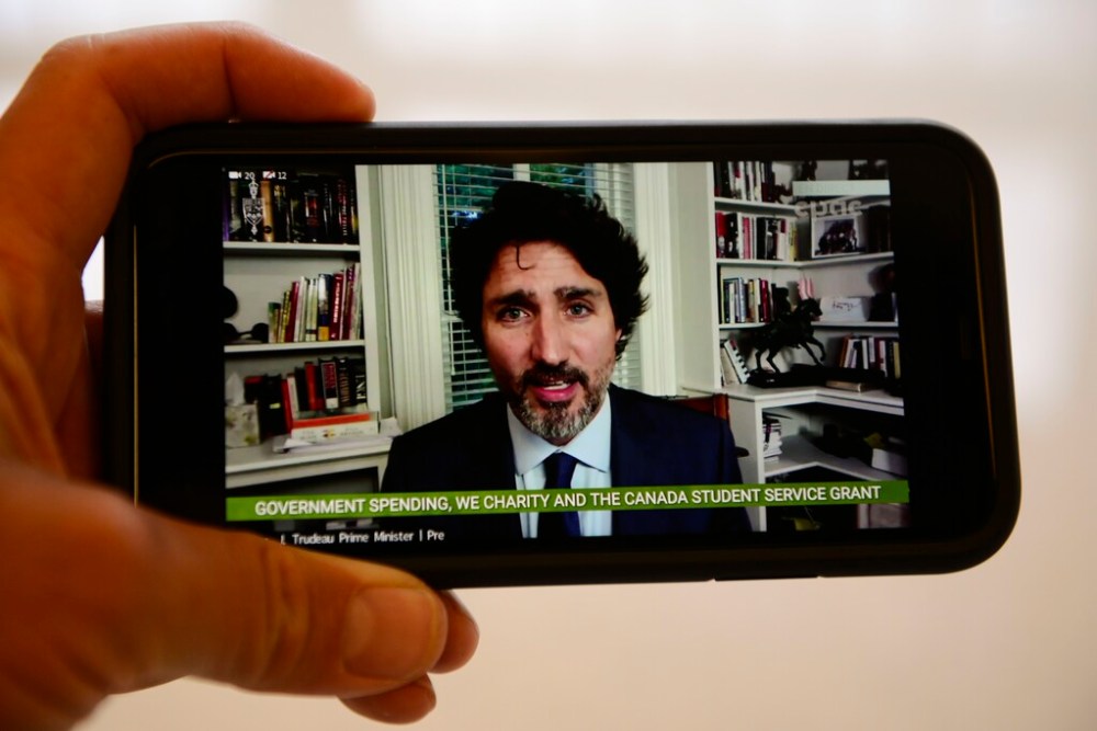 Prime Minister Justin Trudeau is viewed on a mobile phone as he testifies via videoconference during a House of Commons finance committee investigation into the WE Charity scandal. (Sean Kilpatrick / The Canadian Press)