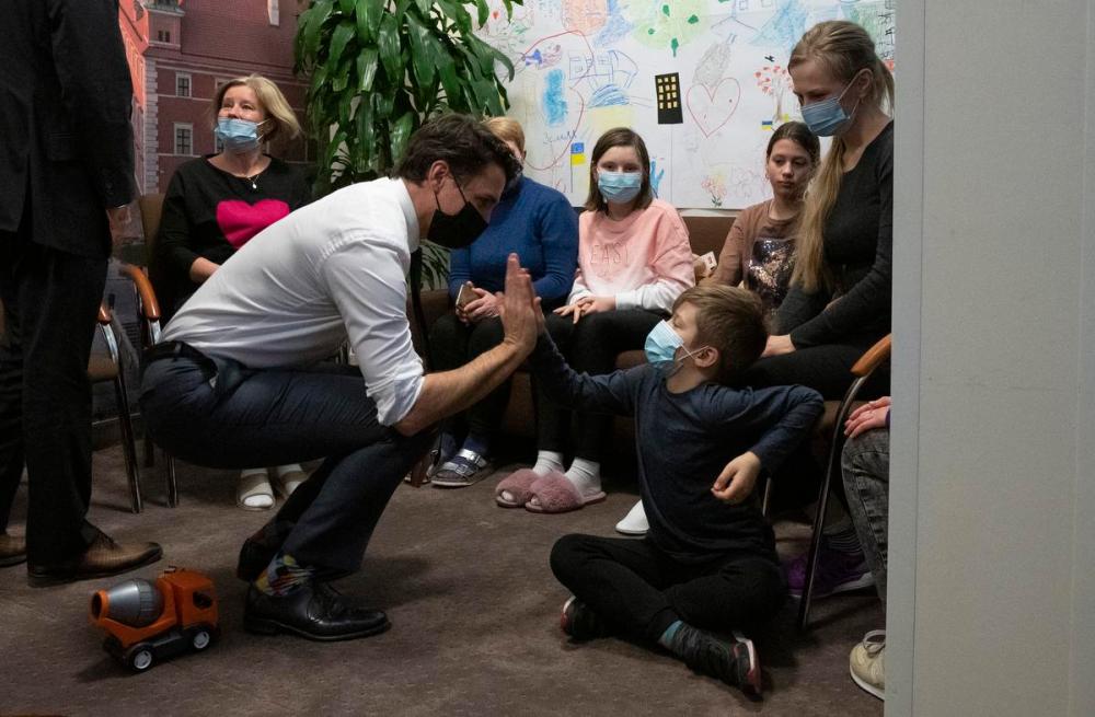 Adrian Wyld - THE CANADIAN PRESS
Canadian Prime Minister Justin Trudeau high fives a young boy as he speaks with Ukrainian refugees in Warsaw, Poland, Thursday, March 10, 2022. THE CANADIAN PRESS/Adrian Wyld