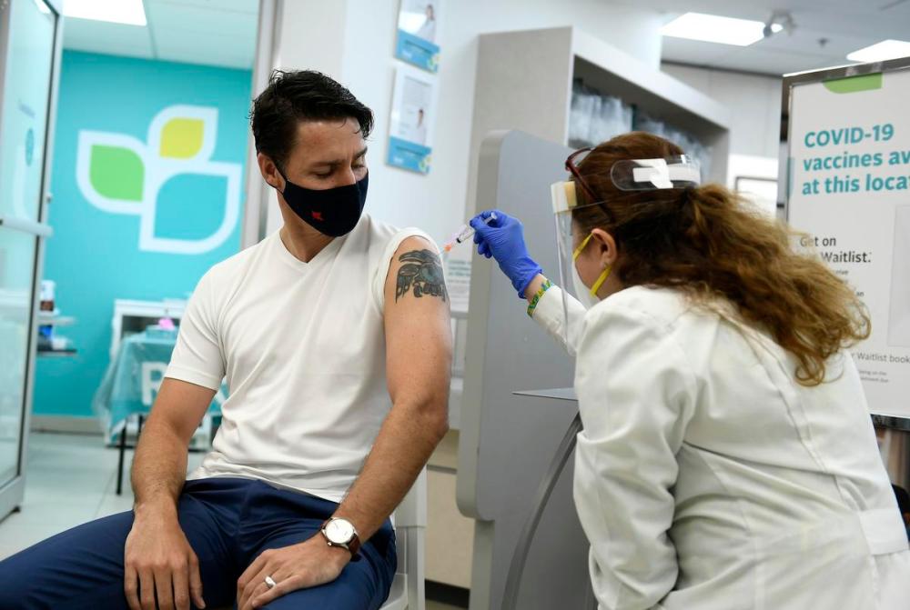 Justin Tang - THE CANADIAN PRESS
Prime Minister Justin Trudeau receives his second dose of COVID-19 vaccine from pharmacist Zaineb Hassan at a pharmacy in Ottawa on July 2, 2021. The federal government’s response to COVID-19, and what happens next, will play a part in the national election.
