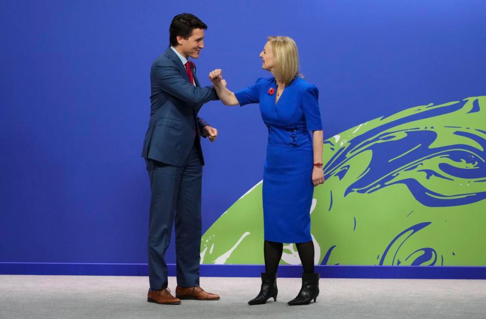 Sean Kilpatrick - THE CANADIAN PRESS
Prime Minister Justin Trudeau is greeted by UK Foreign Secretary Liz Truss as he arrives to COP26 in Glasgow, Scotland, on Nov. 1, 2021. Trudeau has been pointing to Canada as the only oil and gas producer that has figured out how to slap a significant and transparent price on carbon that escalates steeply and redistributes the revenues back to regular people, Heather Scoffield writes.