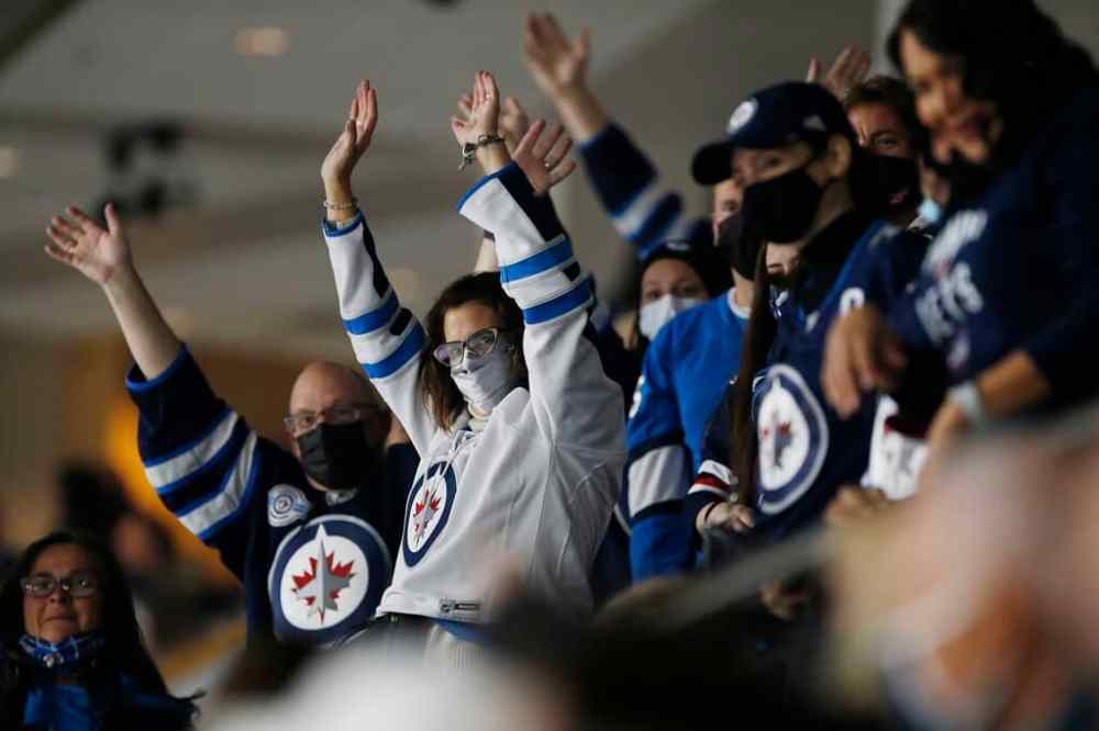 THE CANADIAN PRESS FILES/John Woods
Winnipeg Jets fans cheer at the home opener against the Anaheim Ducks in October.