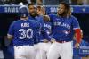 Cole Burston - GETTY IMAGES
Alejandro Kirk is welcomed to the dugout by Vladimir Guerrero Jr. after scoring in the fourth inning. Guerrero later hit his 45th home run, one more than his Hall of Fame father had in his best season.