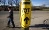 Jeff McIntosh - THE CANADIAN PRESS FILE PHOTO
A voter walks past a sign directing voters to a polling station for the Canadian federal election in Cremona, Alta. on Oct. 19, 2015.