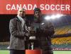 - Canada Soccer photo
Toronto Star sports editor Dave Washburn, left, presents 2020 Lou Marsh co-winner Alphonso Davies with the award in Edmonton. The soccer star, who will lead Canada against Mexico on Tuesday, shared the athlete of the year honour with Laurent-Duvernay Tardif.