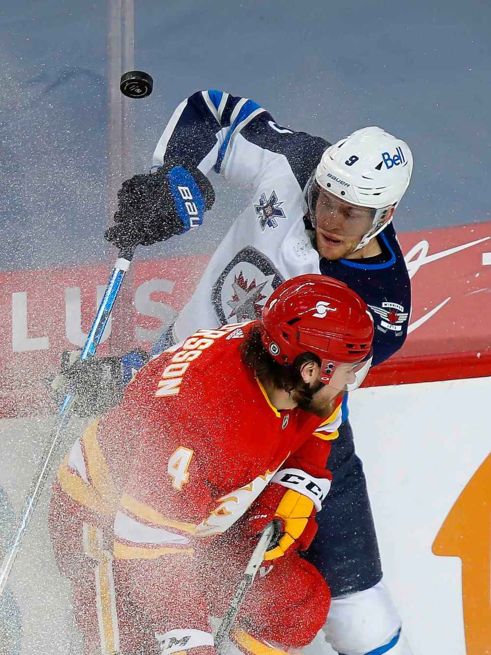 CP
Calgary Flames' Rasmus Andersson and Winnipeg Jets' Andrew Copp (9) battle for the puck during the first period. (Todd Korol / The Canadian Press)