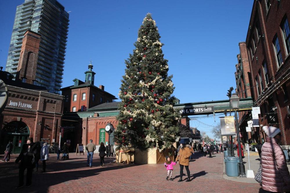 R.J. Johnston - Toronto Star
People walk by the giant Christmas tree in the Distillery District Tuesday. The rise of the highly contagious Omicron variant is making this holiday season complicated. We reached out to experts for their advice on staying safe.