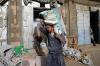 MOHAMMED HUWAIS - AFP via GETTY IMAGES
A Yemeni worker carries a bag of flour outside a wholesale store in the capital Sanaa.