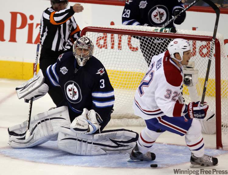 Canadien Travis Moen celebrates a goal in the second period against goalie Ondrej Pavelec. (Joe Bryksa / Winnipeg Free Press)
