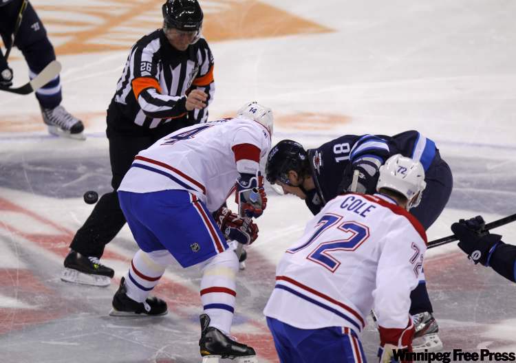Bryan Little faces off against Canadien Tomas Plekanec to start the game. (Boris Minkevich / Winnipeg Free Press)