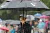 Joe Bryksa /  Winnipeg Free Press
LPGA golfer Michelle Wie copes with a steady rain Saturday morning after finishing during her golf on hole 9.
