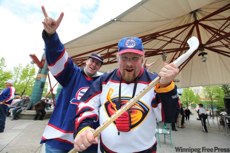 Ruth Bonneville / Winnipeg Free Press
Chris Mackie (Thrashers jersey) and Phil Bonomo (Jets jersey) celebrate the return of the NHL to Winnipeg at the Forks Tuesday afternoon.