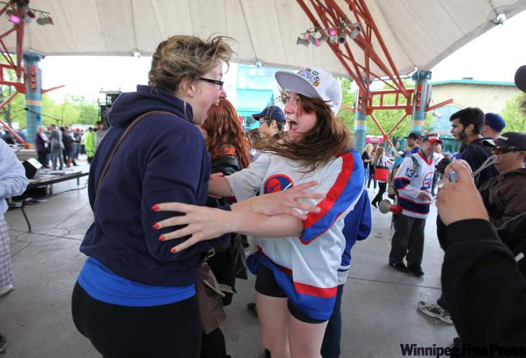Ruth Bonneville Winnipeg Free Press
Katerina Moore (left) and her friend Alisha Long jump for joy after running into each other while celebrating at The Forks Tuesday afternoon.