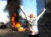 A Canucks fan yells and poses for a friends camera in front of a burning car as fans riot after the Vancouver Canucks lose to the  Boston Bruins in The Stanley Cup final, Vancouver, British Columbia, Canada  on Wednesday, June 15, 2011.   (Gerry Kahrmann/PNG/Postmedia News)