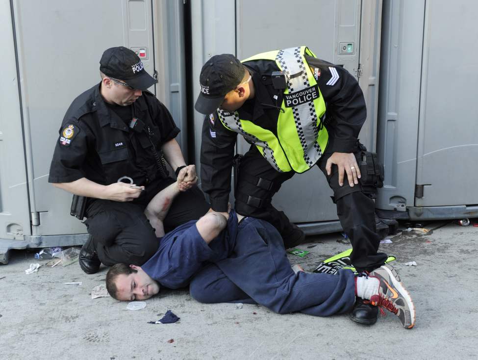 Police detain a man who was rioting after after the Vancouver Canucks lost to the Boston Bruins in the 2011 Stanley Cup final in Vancouver, British Columbia, Canada, on Wednesday, June 15, 2011. (Gerry Kahrmann/PNG/Postmedia News/MCT)