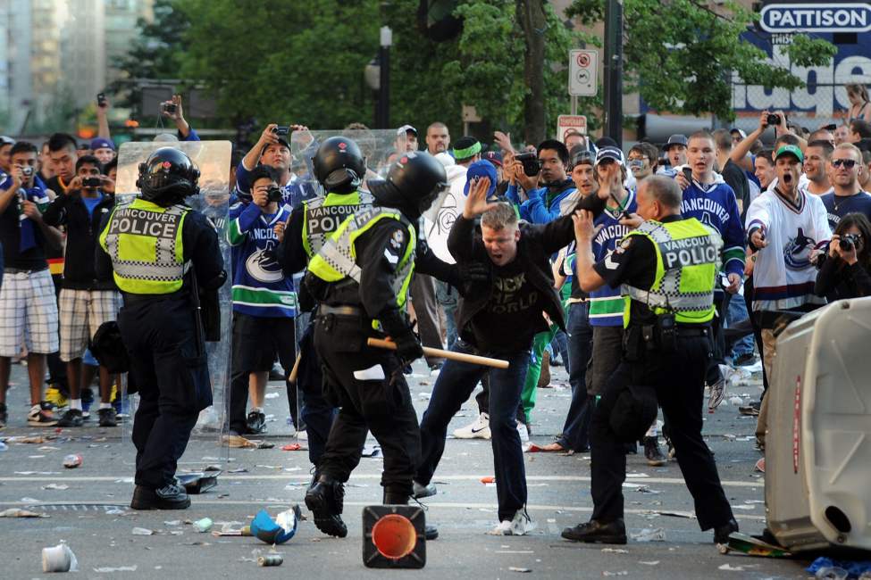 Vancouver police square off against rowdy fans amid rioting after the Vancouver Canucks lose to the Boston Bruins in the 2011 Stanley Cup final in Vancouver, British Columbia, Canada, on Wednesday, June 15, 2011. (Steve Bosch/PNG/Postmedia News/MCT)