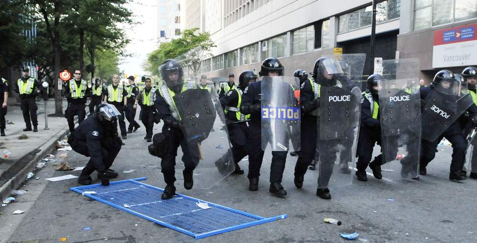 Police charge a group of rioters on Hamilton after the Canucks lost game seven of the 2011 NHL Stanley Cup final Wednesday June 15, 2011 in Vancouver, B.C. ( Ian Lindsay / PNG staff photo)