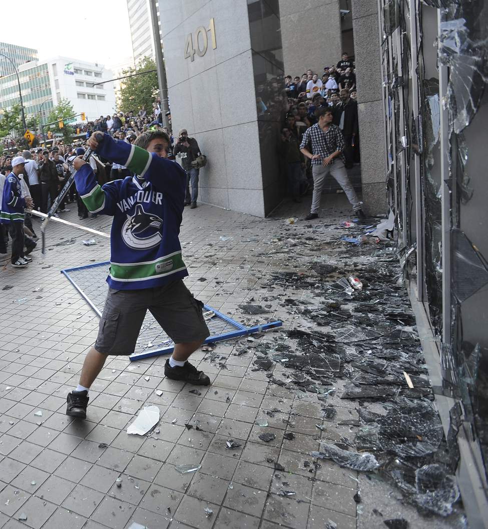 Rioters smash window on a bank on Georgia Street after game 7 of the Stanley Cup finals between the Canucks and the Boston Bruins in Vancouver, BC Wednesday, June 15, 2011. (Photo by Jason Payne/ PNG)