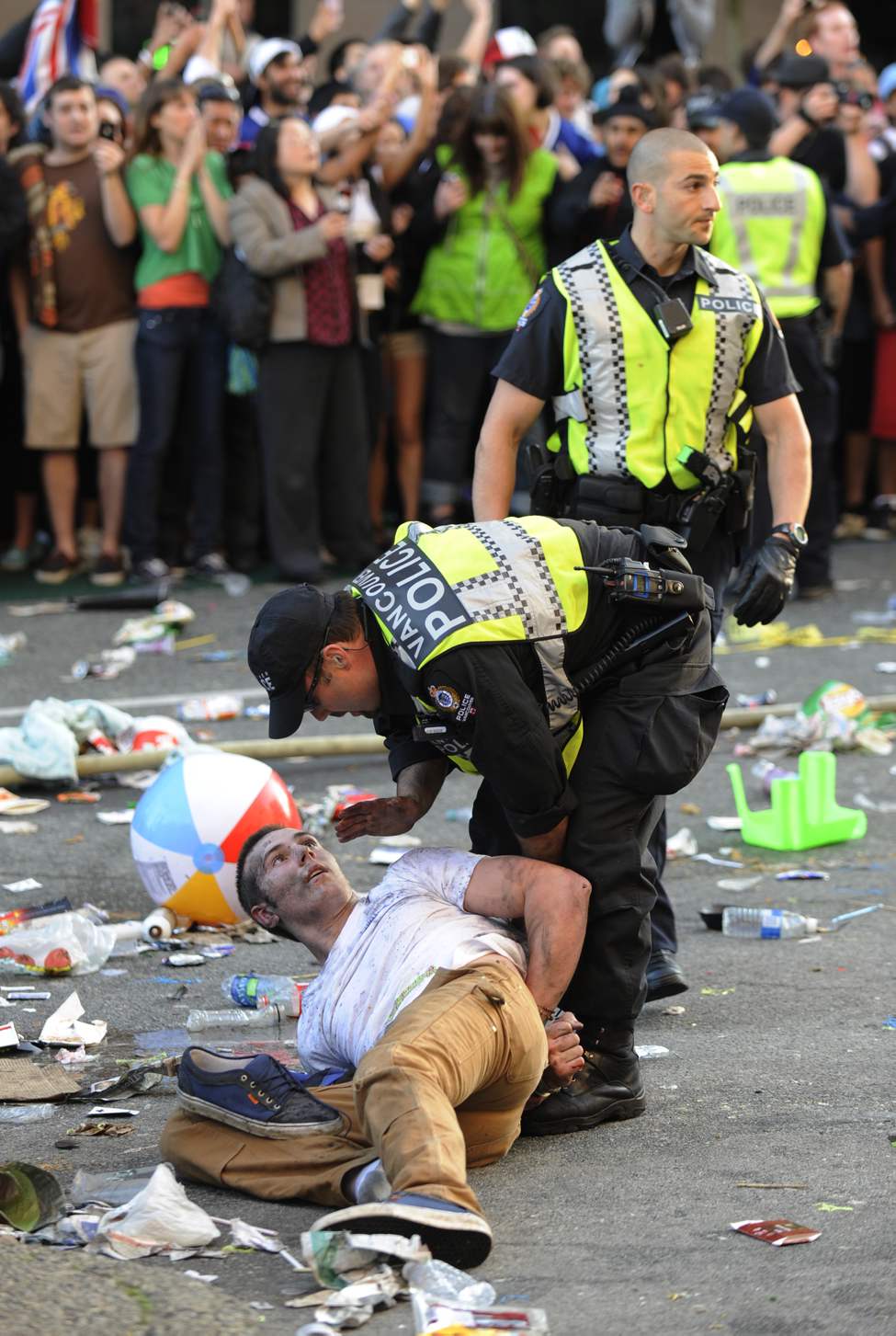 Vancouver Police officer calms a rioter after Vancouver Canucks fans riot after their team lost to the Boston Bruins in NHL Stanley Cup final in Vancouver , B.C. June 15, 2011. (Arlen Redekop photo/ PNG)