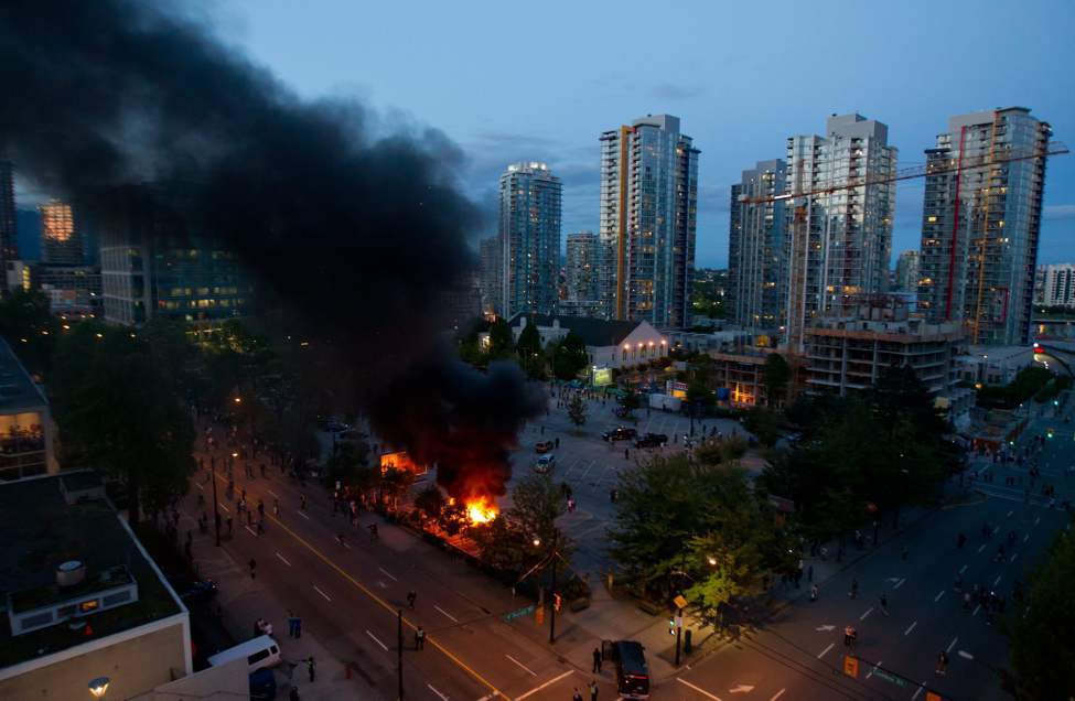 Rioters burn police cars after the Vancouver Canucks were defeated by the Boston Bruins in the NHL's Stanley Cup Final in Vancouver, B.C., on Wednesday June 15, 2011. THE CANADIAN PRESS/Darryl Dyck