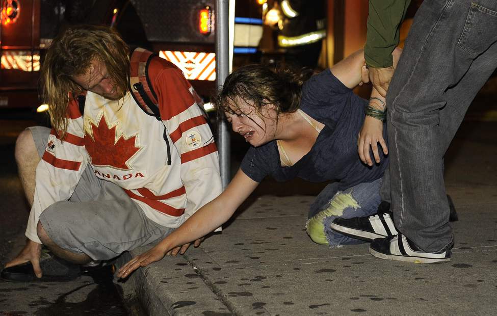 Vancouver Canucks fans is in pain after being involved in the riots after the loss to the Boston Bruins in game 7of the Stanley Cup in Rogers Arena in Vancouver, B.C. on June 15, 2011 (Mark van Manen/PNG)