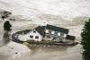 A home breaks apart as it is engulfed by Missouri River flood waters, Wednesday, June, 22, 2011 in the Hoge Island area of Bismarck, N.D. (AP Photo/The Bismarck Tribune, Brian Gehring)