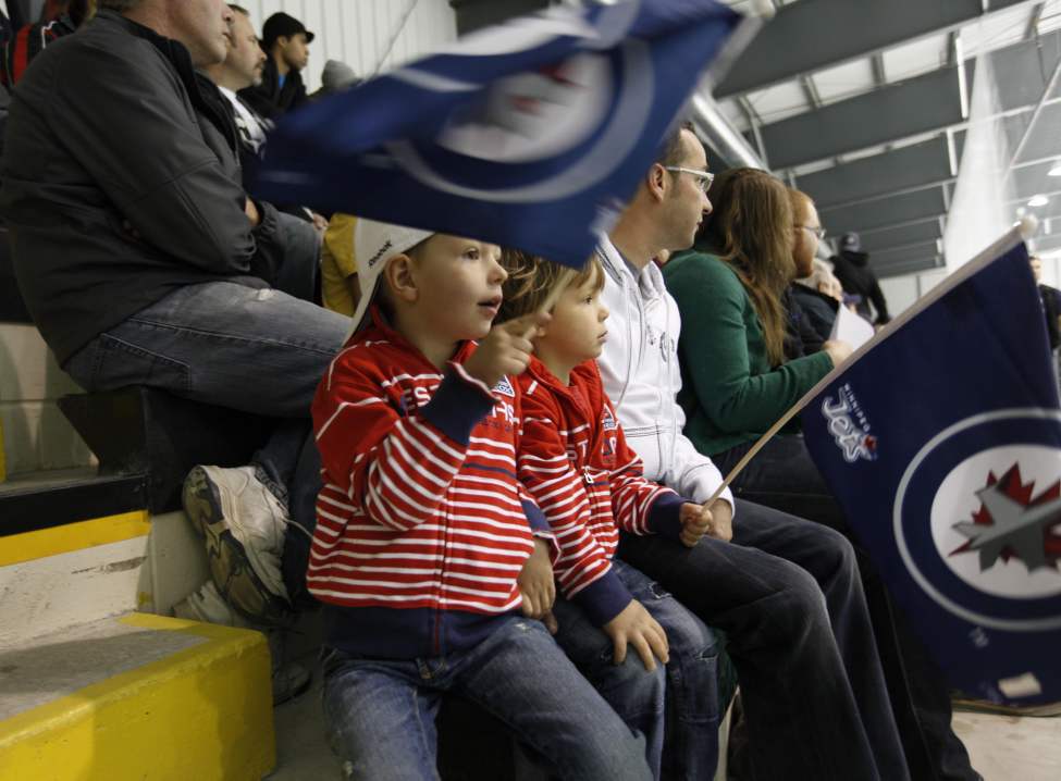 RUTH BONNEVILLE / WINNIPEG FREE PRESS
Mason Vickar, 5, and his brother Vaughan, 3, wave their Jets flags Saturday morning.