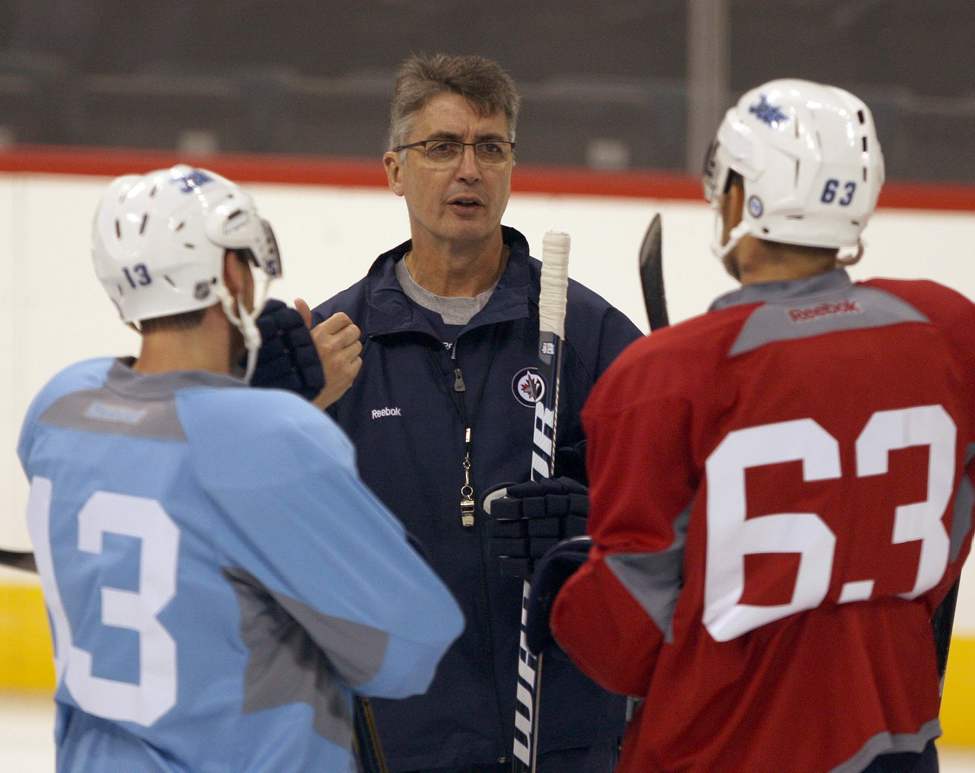 JOE BRYKSA / WINNIPEG FREE PRESS
Head coach Claude Noel talks with players Kyle Wellwood, left, and Ben Chiarot on the ice at the MTS Centre.