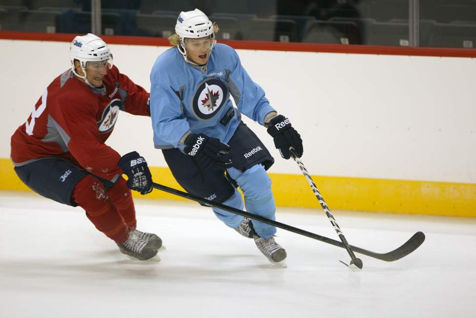 JOE BRYKSA / WINNIPEG FREE PRESS
Kendall McFaull, left, and Michael Forney jostle for the puck at afternoon training camp at the MTS Centre.