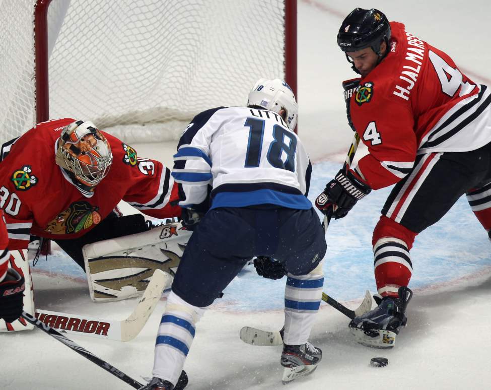 Chicago Blackhawks goaltender Ray Emery, blocks Winnipeg Jets Bryan Little as Blackhawks Nikala Hjalmarsson gives chase during the second period. (Joe Bryksa / Winnipeg Free Press)
