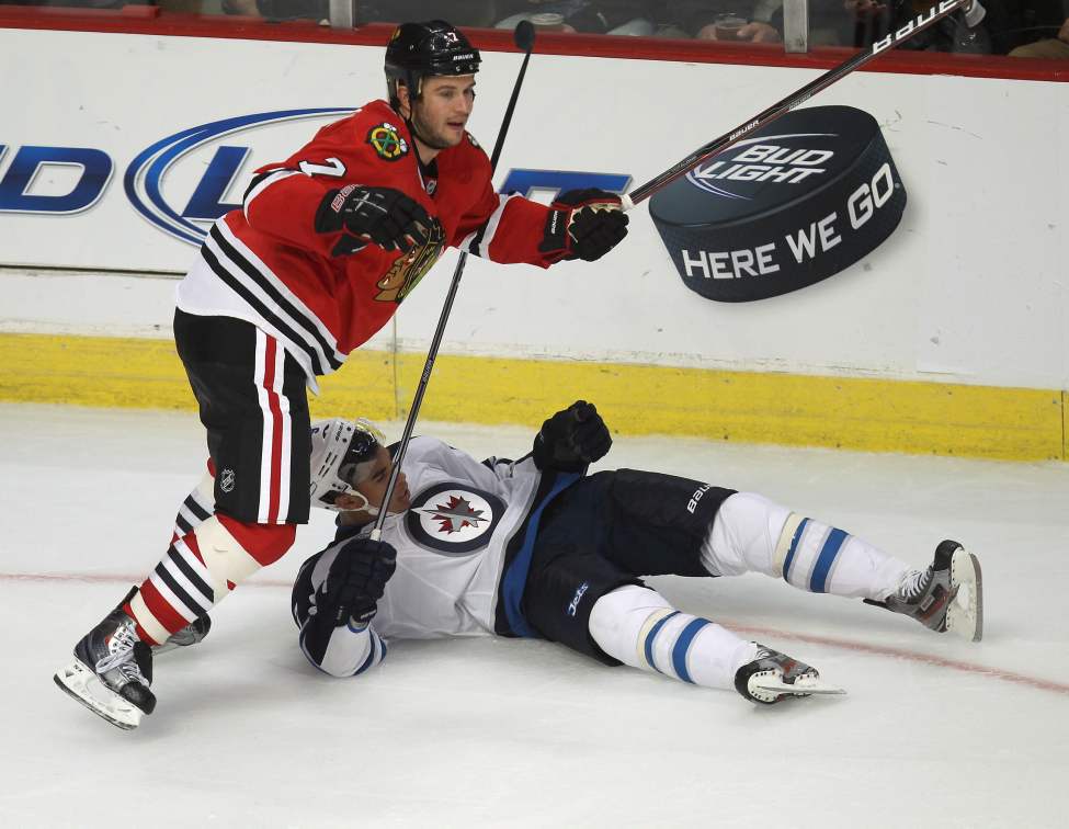 Winnipeg Jets Evander Kane is knocked over in the third period by Chicago Blackhawks Brent Seabrook. (Joe Bryksa / Winnipeg Free Press)