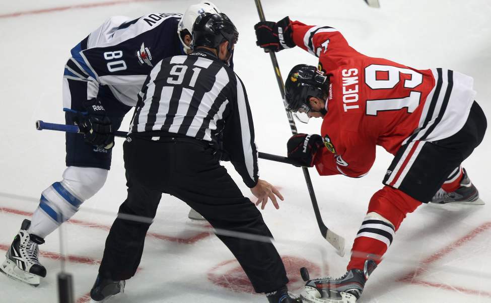Winnipeg Jets Nik Antropov, left, lines up with Chicago Blackhawks Jonathan Toews. (Joe Bryksa / Winnipeg Free Press)