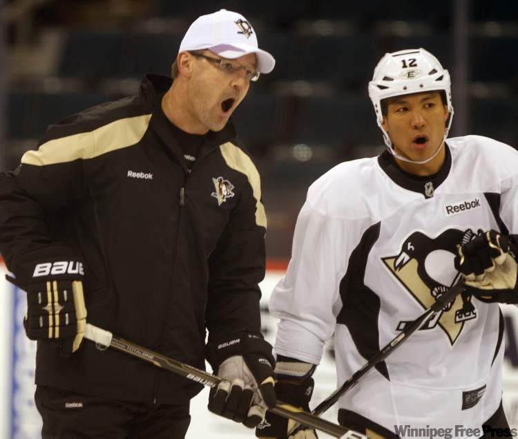 Pittsburgh coach Dan Bylsma gets involved as his team practises at the MTS Centre prior to Monday's game. (Ken Gigliotti / Winnipeg Free Press)