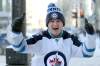 RUTH BONNEVILLE / WINNIPEG FREE PRESS
Winnipeg Jets fan Luke Wiebe cheers on his team and gives the two-thumbs-up as he rushes across Portage Avenue at Donald Street heading to the Jets game at the MTS Centre with his brother Nathan.  This is the first NHL Jets game of the season after a long lockout.