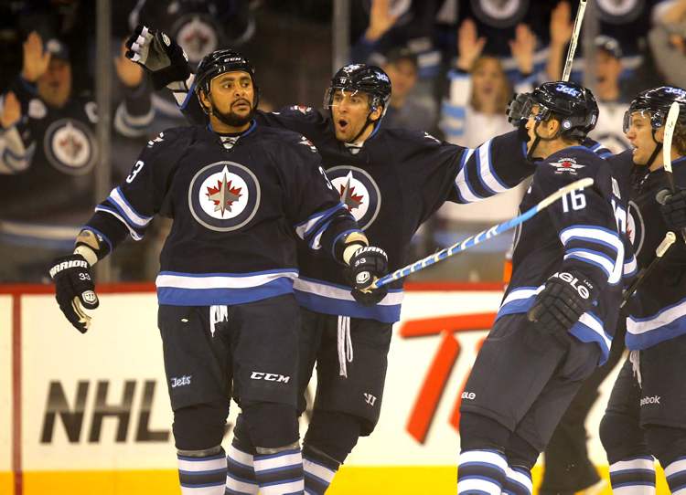 BORIS MINKEVICH / WINNIPEG FREE PRESS
Winnipeg Jets Dustin Byfuglien is congratulated by his teammates on his first goal of the year against the Ottawa Senators at the MTS Centre in Winnipeg.