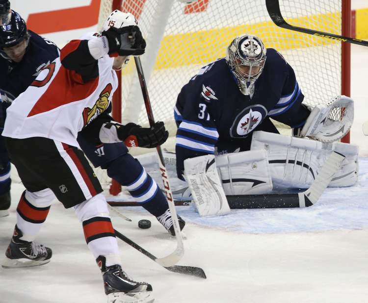 REVOR HAGAN / WINNIPEG FREE PRESS
Winnipeg Jets' goaltender Ondrej Pavelec (31) stops Ottawa Senators' Zach Smith (15) during the first period.
