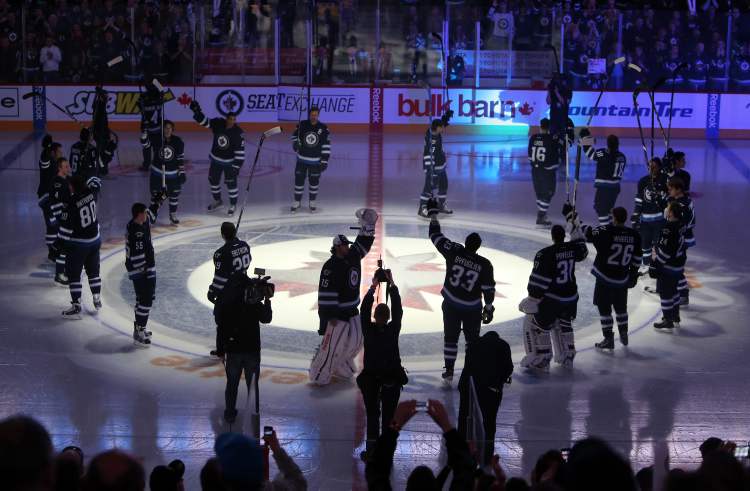 TREVOR HAGAN/WINNIPEG FREE PRESS
The Winnipeg Jets salute the crowd prior to the first game of the season at MTS Centre, Saturday, January 19, 2013.